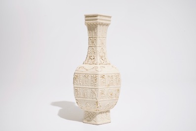 A Chinese white-glazed relief-decorated vase with text bands, 19th C.