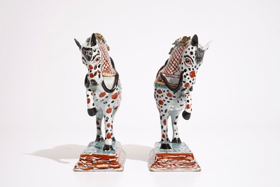 A pair of Dutch Delft polychrome petit feu models of horses, 18th C.