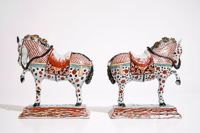 A pair of Dutch Delft polychrome petit feu models of horses, 18th C.