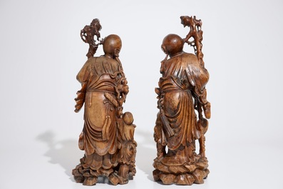 A pair of tall Chinese carved wood figures of immortals, 19/20th C.