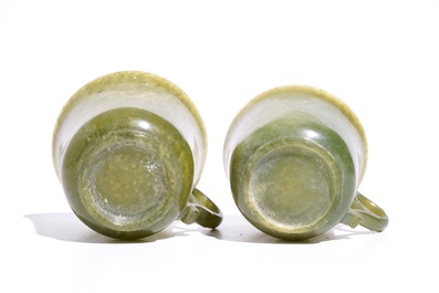 A pair of Chinese green jade cups and saucers, 19th C.