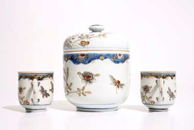 A pair of Chinese grisaille, gilt and iron red cups and saucers and a covered bowl, Qianlong