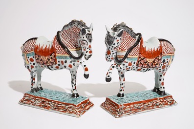 A pair of Dutch Delft polychrome petit feu models of horses, 18th C.