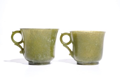 A pair of Chinese green jade cups and saucers, 19th C.