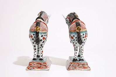 A pair of Dutch Delft polychrome petit feu models of horses, 18th C.