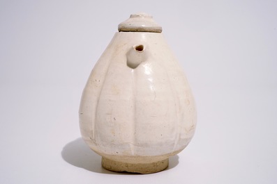 A Chinese cream-glazed melon-shaped ewer and cover, Song