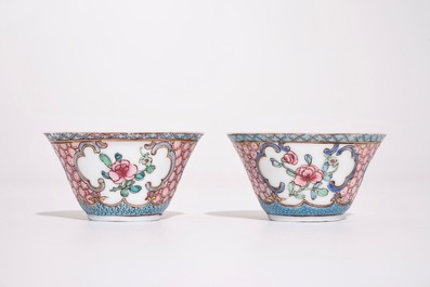 A pair of Chinese famille rose cups and saucers with a cat near a flower basket, Yongzheng