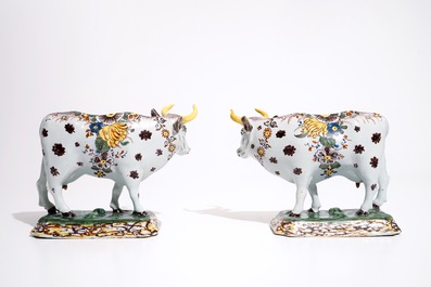 A pair of large polychrome Dutch Delft models of cows, 18th C.