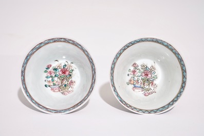 A pair of Chinese famille rose cups and saucers with a cat near a flower basket, Yongzheng