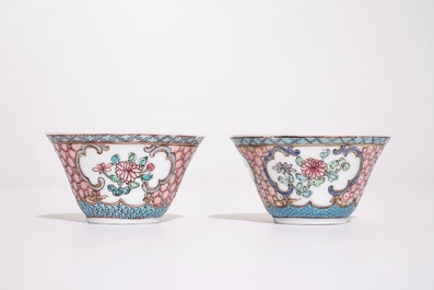 A pair of Chinese famille rose cups and saucers with a cat near a flower basket, Yongzheng