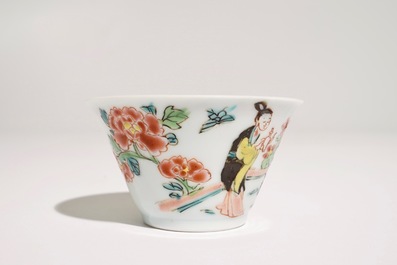 A Chinese famille rose cup and saucer with a tea-drinking scene, Yongzheng