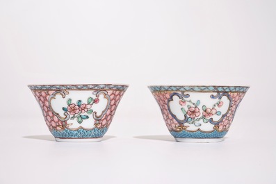 A pair of Chinese famille rose cups and saucers with a cat near a flower basket, Yongzheng