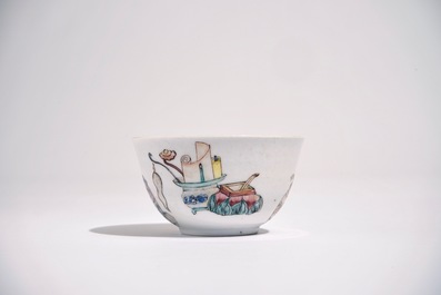 A Chinese famille rose cup and saucer with a lady and a boy, Yongzheng