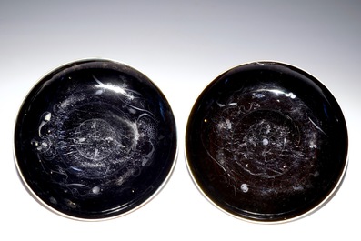 A pair of Chinese monochrome dark aubergine plates with traces of gilding, Kangxi