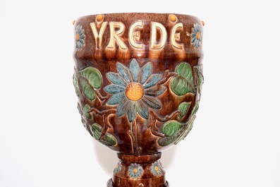 A large collection of Flemish pottery, mostly jardinieres on stands, early 20th C.