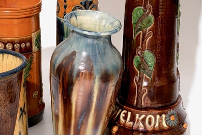 A large collection of Flemish pottery, mostly jardinieres on stands, early 20th C.