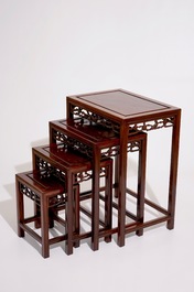 A set of four Chinese sculpted hardwood stacking tables, 20th C.