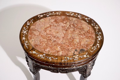 An oval Chinese marble-top mother of pearl inlaid sculpted wood stand, 19th C.