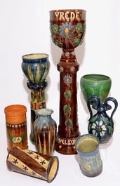 A large collection of Flemish pottery, mostly jardinieres on stands, early 20th C.