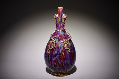 A Chinese monochrome flambe-glazed bottle vase with dragon handles, 19th C.