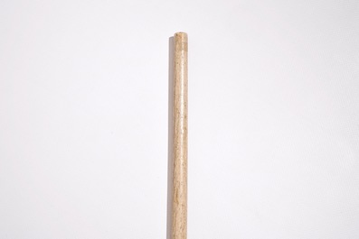 A scrimshaw whalebone cane with a sperm whale tooth handle, 19th C.