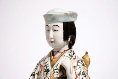 A blue and white Arita jug and a plate, 17/18th C., with an Imari figure, 18/19th C.