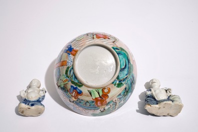 Two Chinese blue and white glazed biscuit figures of boys, Qianlong, and a Canton famille rose bowl, 19th C.