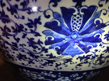A pair of Chinese blue and white lotus scroll fishbowls, 19th C.