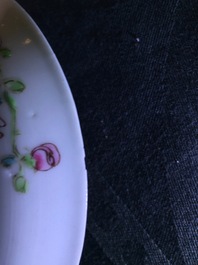 A pair of Chinese famille rose cups and saucers with a cat near a flower basket, Yongzheng