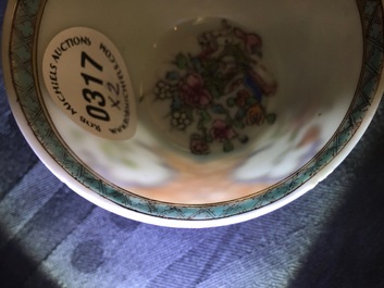 A pair of Chinese famille rose cups and saucers with a cat near a flower basket, Yongzheng