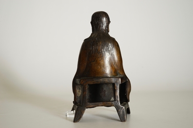 A Chinese bronze model of a seated Zhenwu, Ming