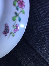 A pair of Chinese famille rose cups and saucers with a cat near a flower basket, Yongzheng