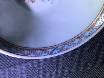 A pair of Chinese famille rose cups and saucers with a cat near a flower basket, Yongzheng