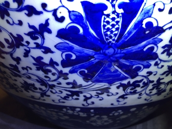 A pair of Chinese blue and white lotus scroll fishbowls, 19th C.