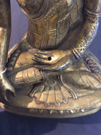 A Chinese gilt bronze figure of Buddha, 18/19th C.