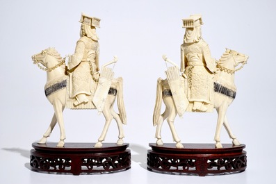 A pair of Chinese ivory warriors on horseback on wooden bases, 19th C.