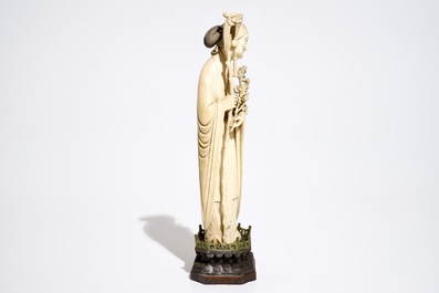 A Chinese ivory model of a lady on wooden base, 19th C.