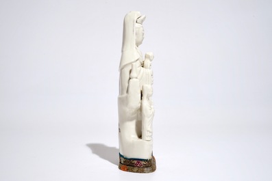 A Chinese Dehua blanc de Chine model of Guanyin with a child and acolytes, Kangxi