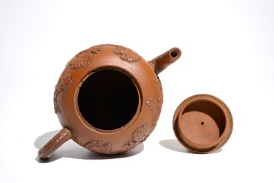 A Chinese Yixing stoneware teapot and cover with applied decoration, Kangxi