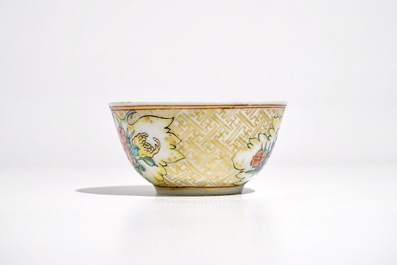 A Chinese famille rose cup and saucer with an insect on sanduo fruit, Yongzheng