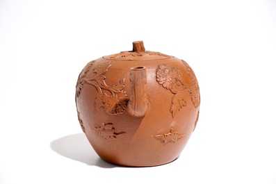 A Chinese Yixing stoneware teapot and cover with applied decoration, Kangxi