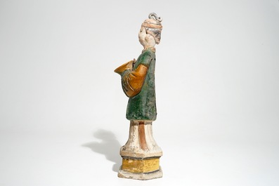 A large Chinese sancai-glazed model of a servant on base, Ming