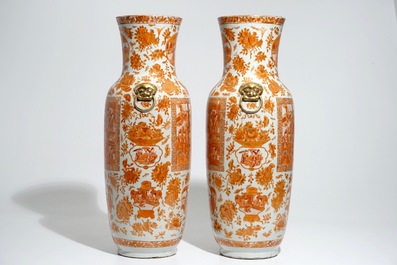 A pair of tall Chinese iron red and gilt vases, 19th C.