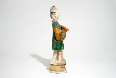 A large Chinese sancai-glazed model of a servant on base, Ming