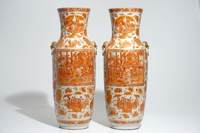 A pair of tall Chinese iron red and gilt vases, 19th C.