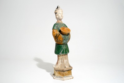 A large Chinese sancai-glazed model of a servant on base, Ming