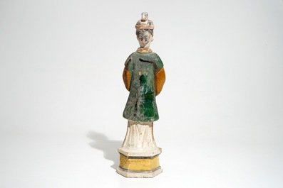 A large Chinese sancai-glazed model of a servant on base, Ming
