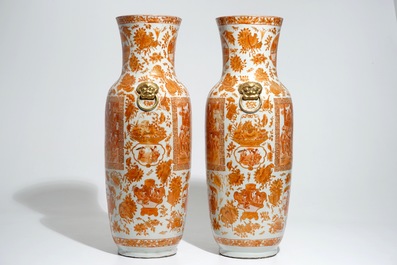 A pair of tall Chinese iron red and gilt vases, 19th C.