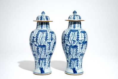 A pair of Chinese blue and white vases and covers with grapes, Kangxi