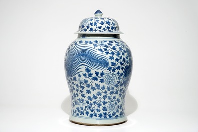 A tall Chinese blue and white baluster jar and cover with a phoenix, 19th C.